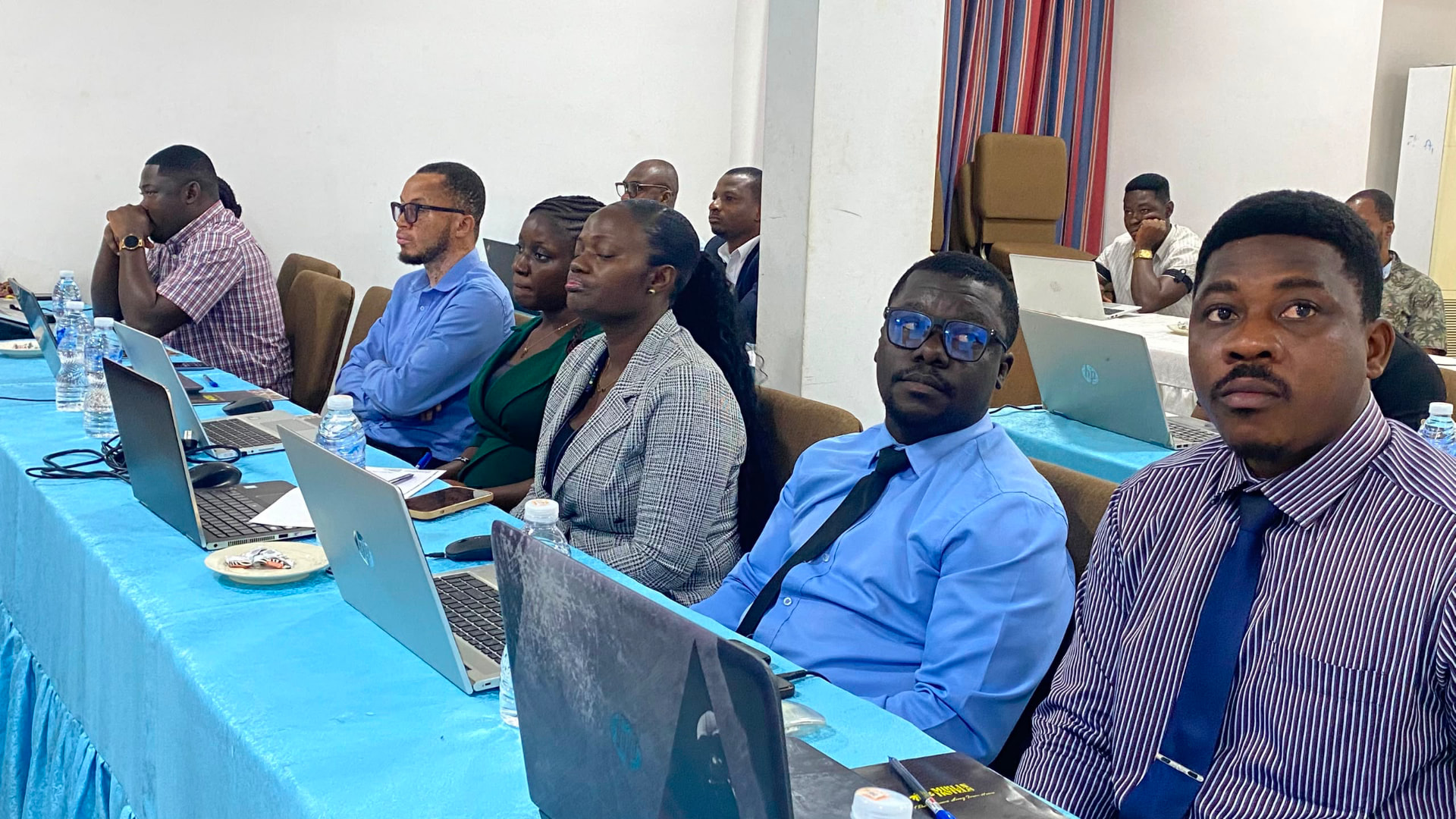 Audit professionals following an in-person session with laptops open