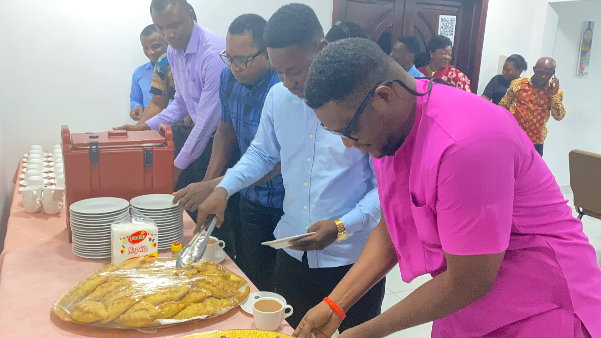 Participants networking during a refreshment break at an in-person training programme